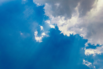 Fototapeta na wymiar Sunbeam Shine through the cloud on the blue sky