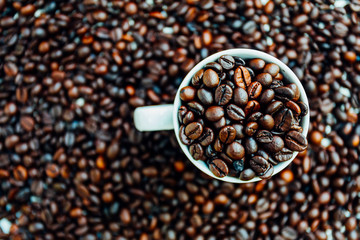 Coffee beans in cup top view