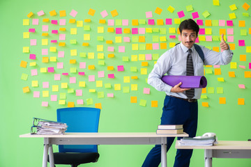 Man in the office with many conflicting priorities preparing go 