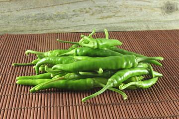 
garden fresh isolated chili pepper in wooden background