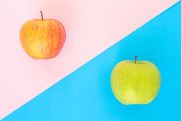 red apple and green apple on pink blue rose quartz serenity background