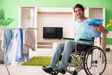 Disabled man on wheelchair doing laundry