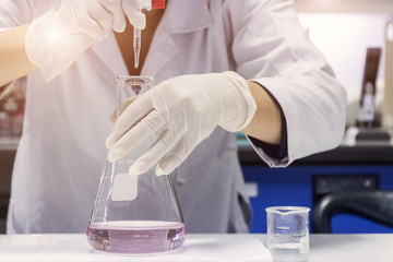 Chemist is testing chemical by titration technique in chemical laboratory