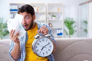 Man frustrated at bills he needs to pay in time management conce