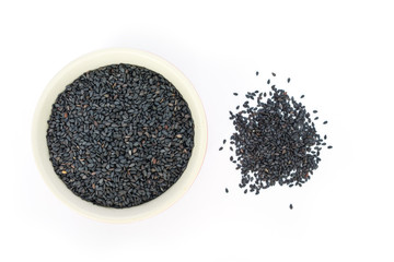 Black sesame in white bowl on white background top view.