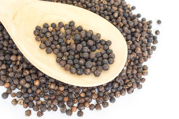 peppercorns in spoon heap on white background.
