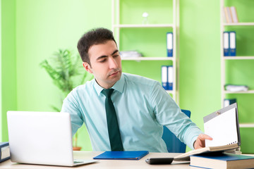 Naklejka premium Male financial manager working in the office 