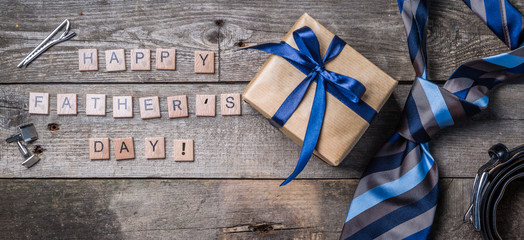 Father's day concept - present, tie on rustic wood background