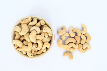 cashew in white bowl top view on white background.