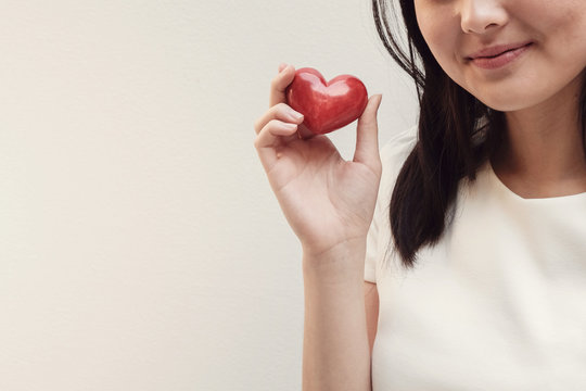 Asian Young Woman Holding Red Heart, Health Insurance, Donation, Charity, CSR Concept, Stop Asian Hate