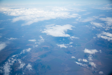 Clouds and sky as seen through window of an aircraft