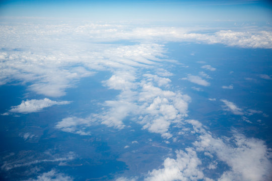 Clouds and sky as seen through window of an aircraft