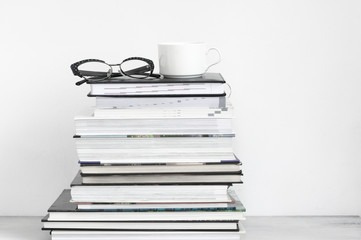 Fototapeta premium Cup of coffee on stack of books