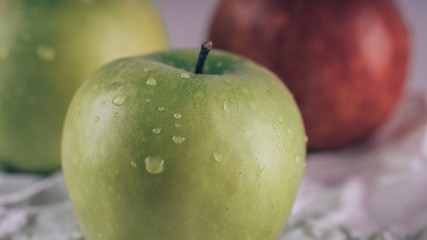 Juicy and delicious Apple lying on the table, fruit on the table. Apples on white background. The concept of healthy eating.
