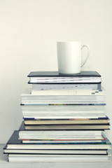 Cup of coffee on stack of books