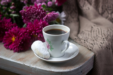 Autumn still life with coffee, homemade biscuits vanilla crescents, chrysanthemums and plaid.