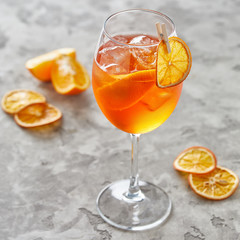 Close-up view of fresh orange alcohol cocktail on grey table 