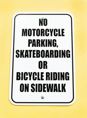 No Mortorcycle Parking Skateboarding or Bicucle Riding on Sidewalk Sign