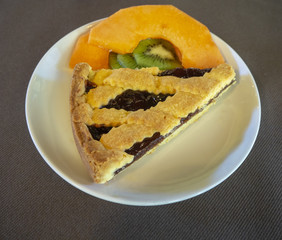 Breakfast: dish with home made jam tart, croissant, melon and kiwi fruit