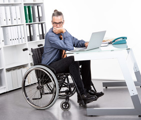 disabled business man in wheelchair is sorrwoful