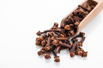 fragrant cloves on a white acrylic background