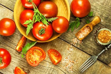 Fresh tomatoes and pink Himalayan salt. Vegetable growing. Sale of tomatoes. Advertising space for text.