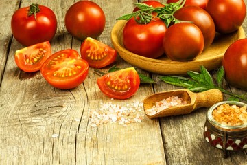Fresh tomatoes and pink Himalayan salt. Vegetable growing. Sale of tomatoes. Advertising space for text.
