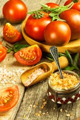 Fresh tomatoes and pink Himalayan salt. Vegetable growing. Sale of tomatoes. Advertising space for text.