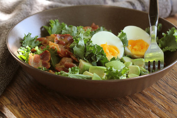 Vegan salad with kale,avocado, crispy bacon, egg and Vinaigrette dressing