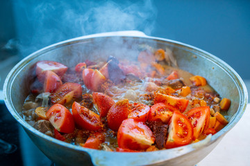In a saucepan cook the food with tomatoes
