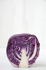 Half of red cabbage, closeup. Side view. Space for text.