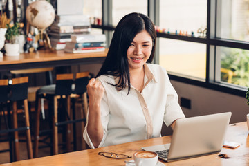 Lifestyle freelance business woman working with laptop computer he has glad on the job