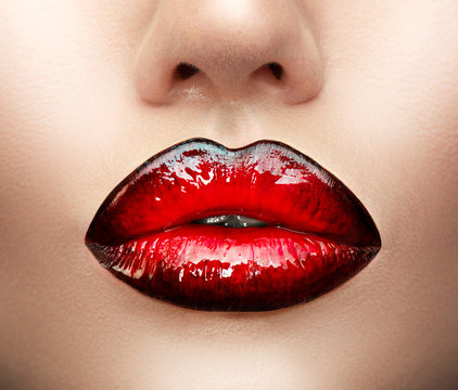 Lips makeup. Beauty high fashion gradient lips makeup sample, black with red color. Sexy mouth closeup. Lipstick