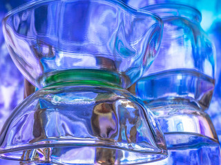 Glass of water with drop and colored background