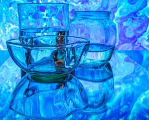 Glass of water with drop and colored background