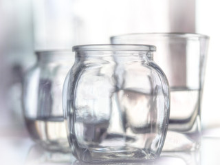 Glass of water with drop and colored background