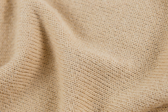 Industrial knitted textile in nude color as background