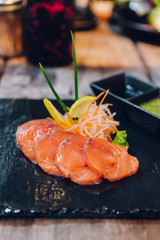 Sliced raw salmon served as appetizer. Served with Thai spicy sauce.