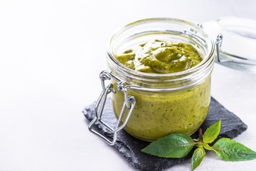 Pesto sauce in glass jar. 