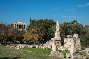 Fototapeta na wymiar Odeon of Agrippa statues with Temple of Hephaestus at background. Ancient Agora of Athens, Greece
