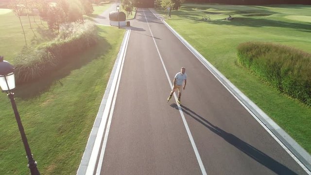 The old man rollerblading in the picturesque park. quadrocopter shot