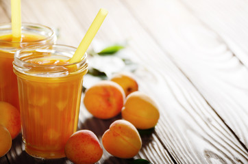 Apricot smoothie in mason jar on wooden table
