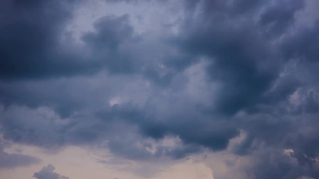 Clouds running across the rapidly darkening sky at sunset. Timelapse video