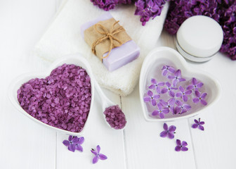 Fototapeta na wymiar Spa towel and massage products with lilac flowers