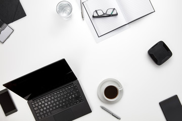 Devices And Office Supplies On White Desk