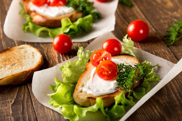 Homemade Burger with tomatoes and lettuce. Fast food.