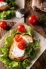 Homemade Burger with tomatoes and lettuce. Fast food.