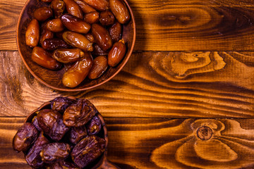 Date fruits on a wooden table. Top view