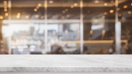 Empty white stone marble table top and blurred abstract background from interior cafe space background - can used for display or montage your products.