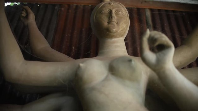Idol of Maa Durga, an Indian Goddess with ten hands being made with clay in India, Kolkata. Slow camera upward movement
